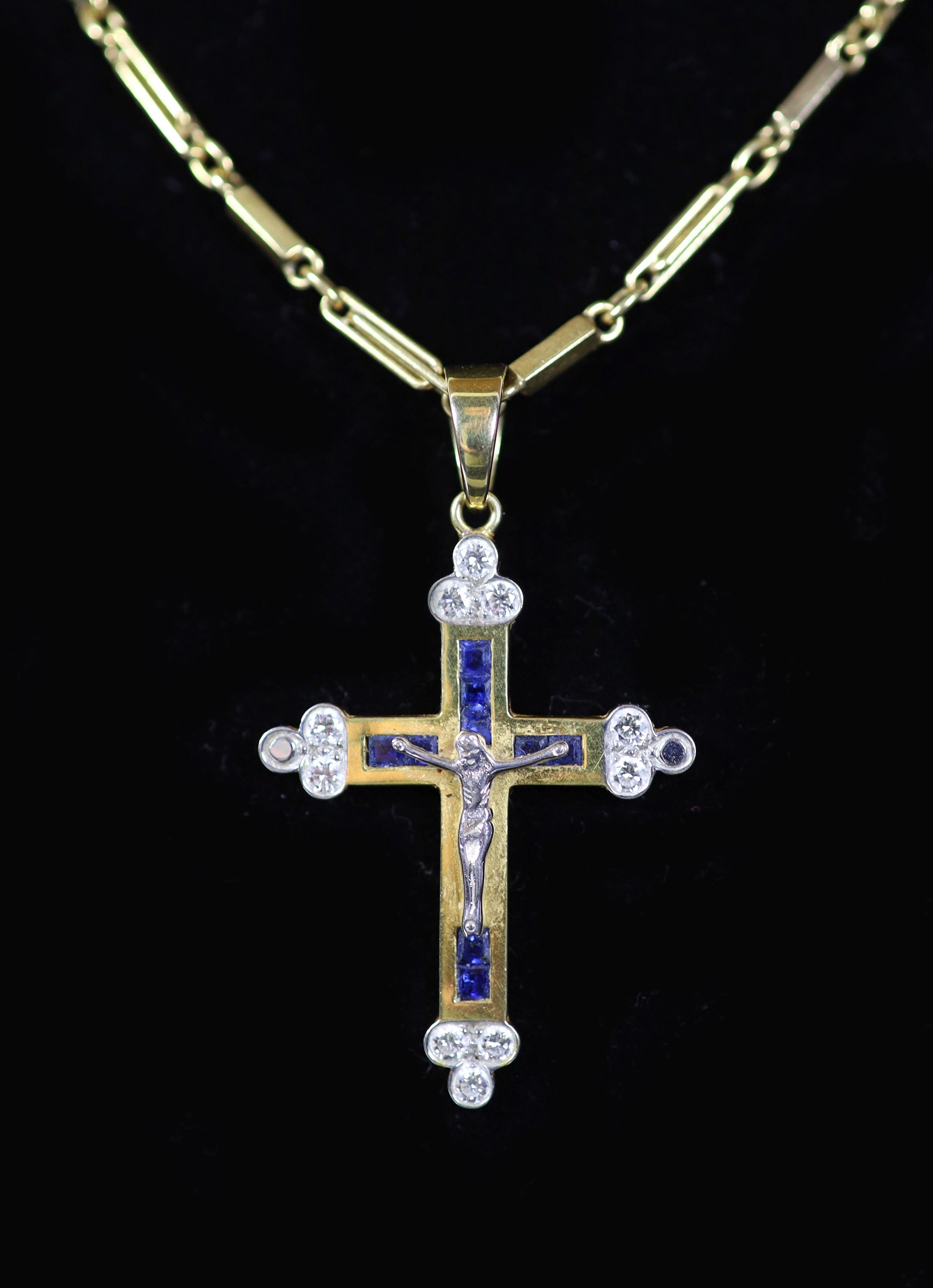 A modern 750 gold, sapphire and diamond set crucifix pendant, on a similar bar link chain